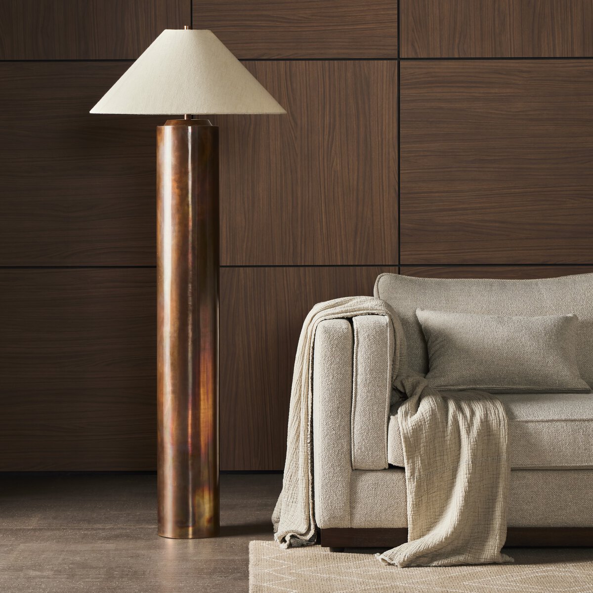  All-metal contemporary floor lamp, complemented by a simple linen, tapered shade.