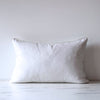 White linen lumbar pillow cover with white lace trim on edges