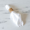White linen napkin with seagrass napkin ring