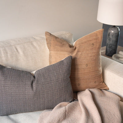 Remi Woven pillow cover styled on cream couch