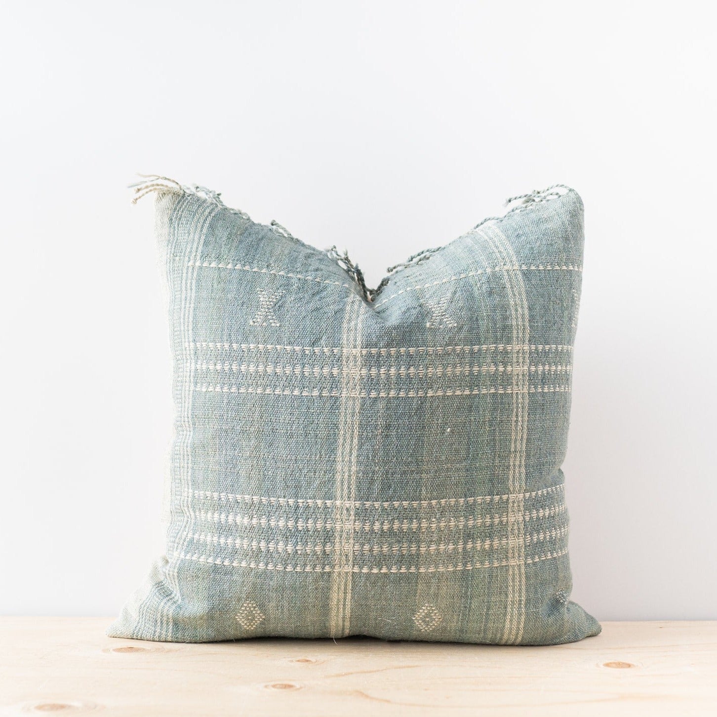 Square sage bhujodi pillow cover with fringe along top