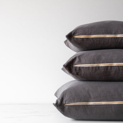 Stack of double sided charcoal linen pillow covers