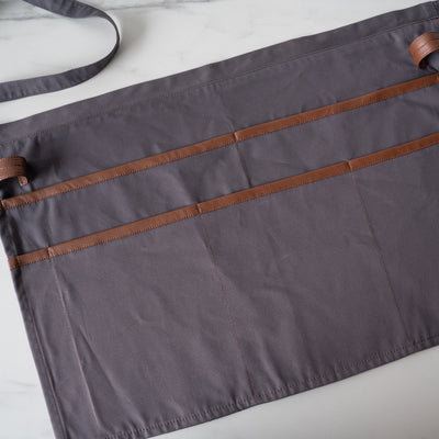 Grey utility apron with multi pocket front